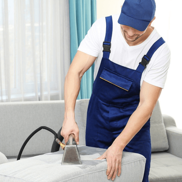 Professional house cleaning service in Wake County NC showing trained cleaner dusting and sanitizing a modern suburban living room interior